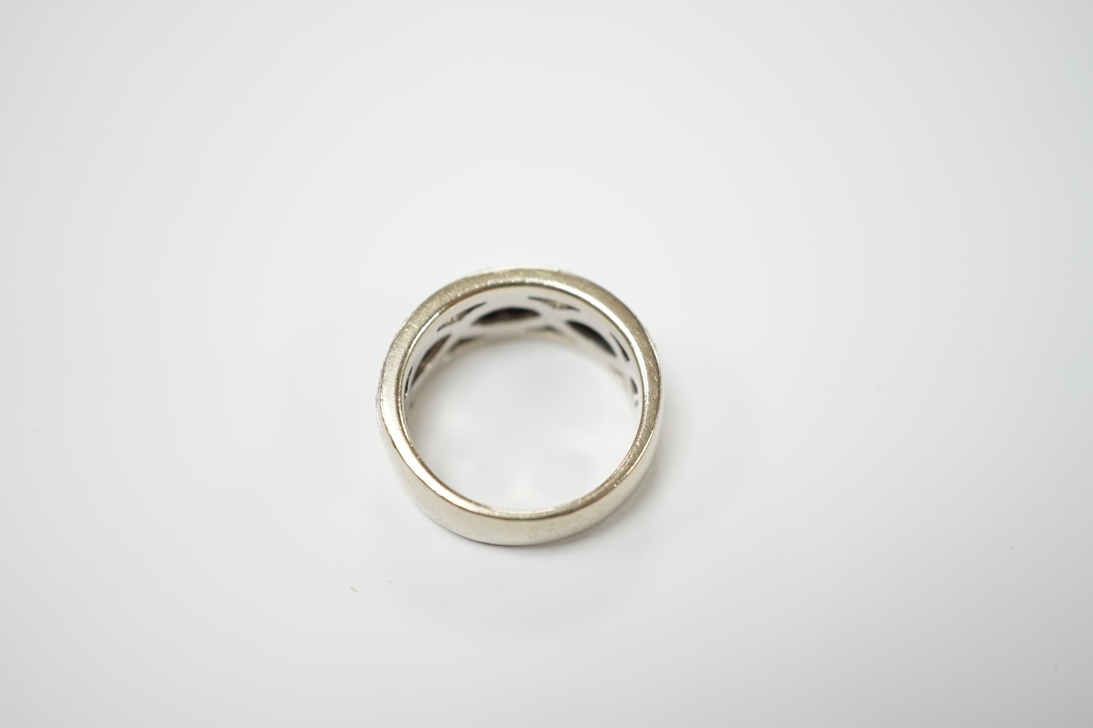 A modern 14ct gold and diamond chip set spiral band cluster half hoop ring, size L, gross weight 7.3 grams.